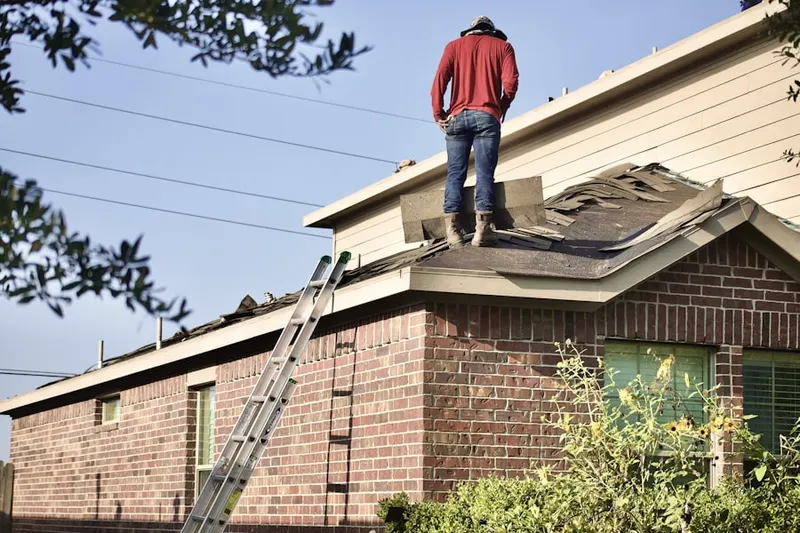 Professional roofer working on a residential roof in Fox Chase